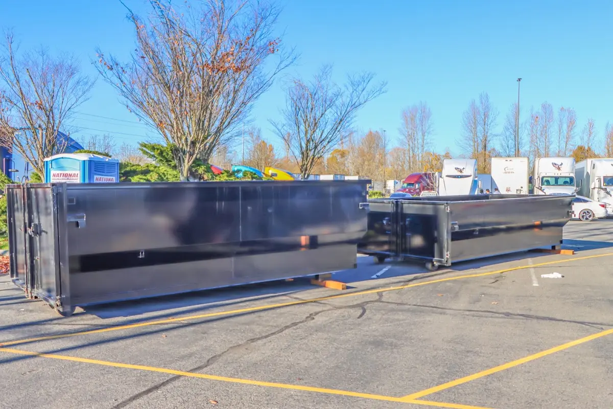 Professional dumpster rental service with roll-off container on residential driveway in Front Royal